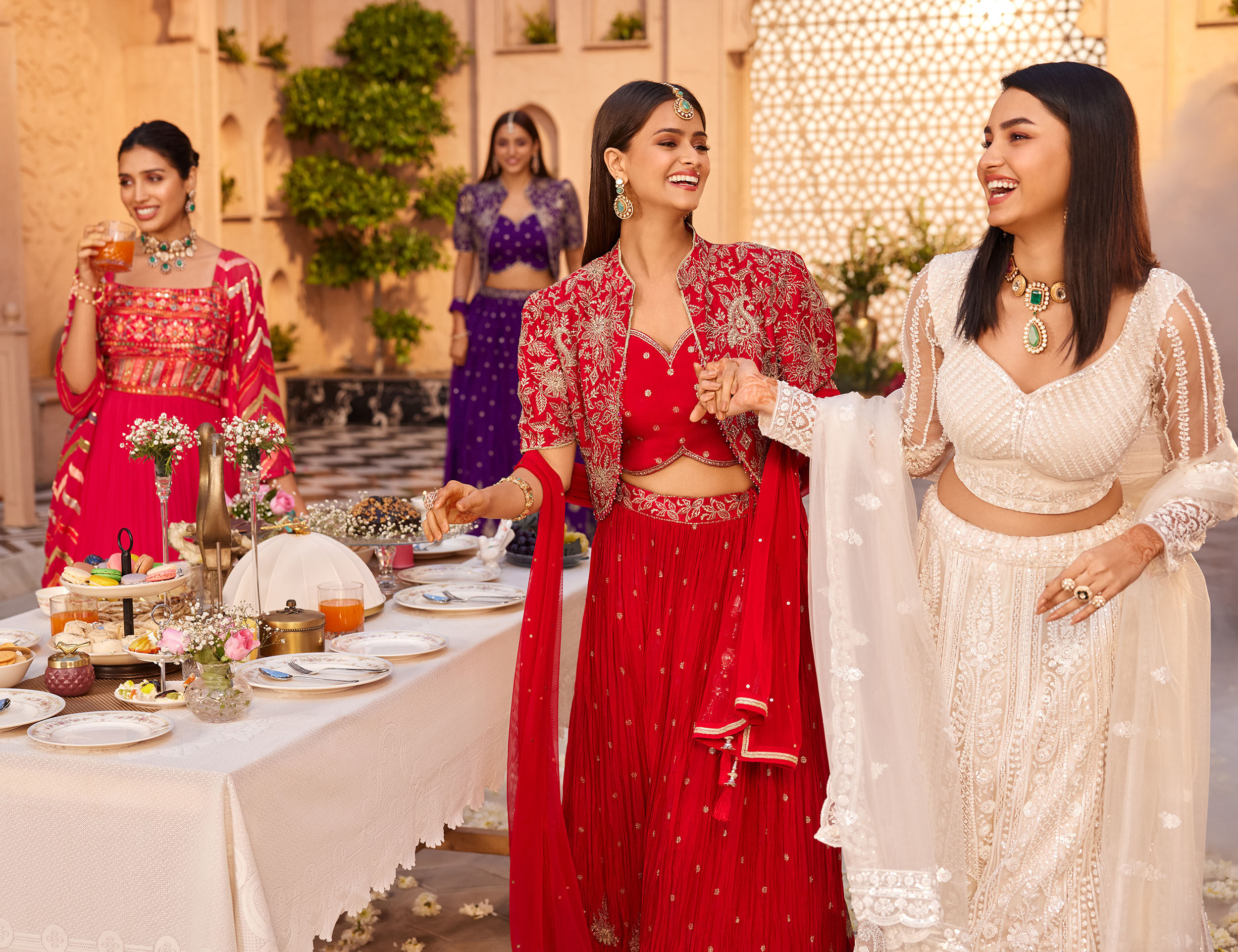 Womens flaunting their colourfull indo western lehengas